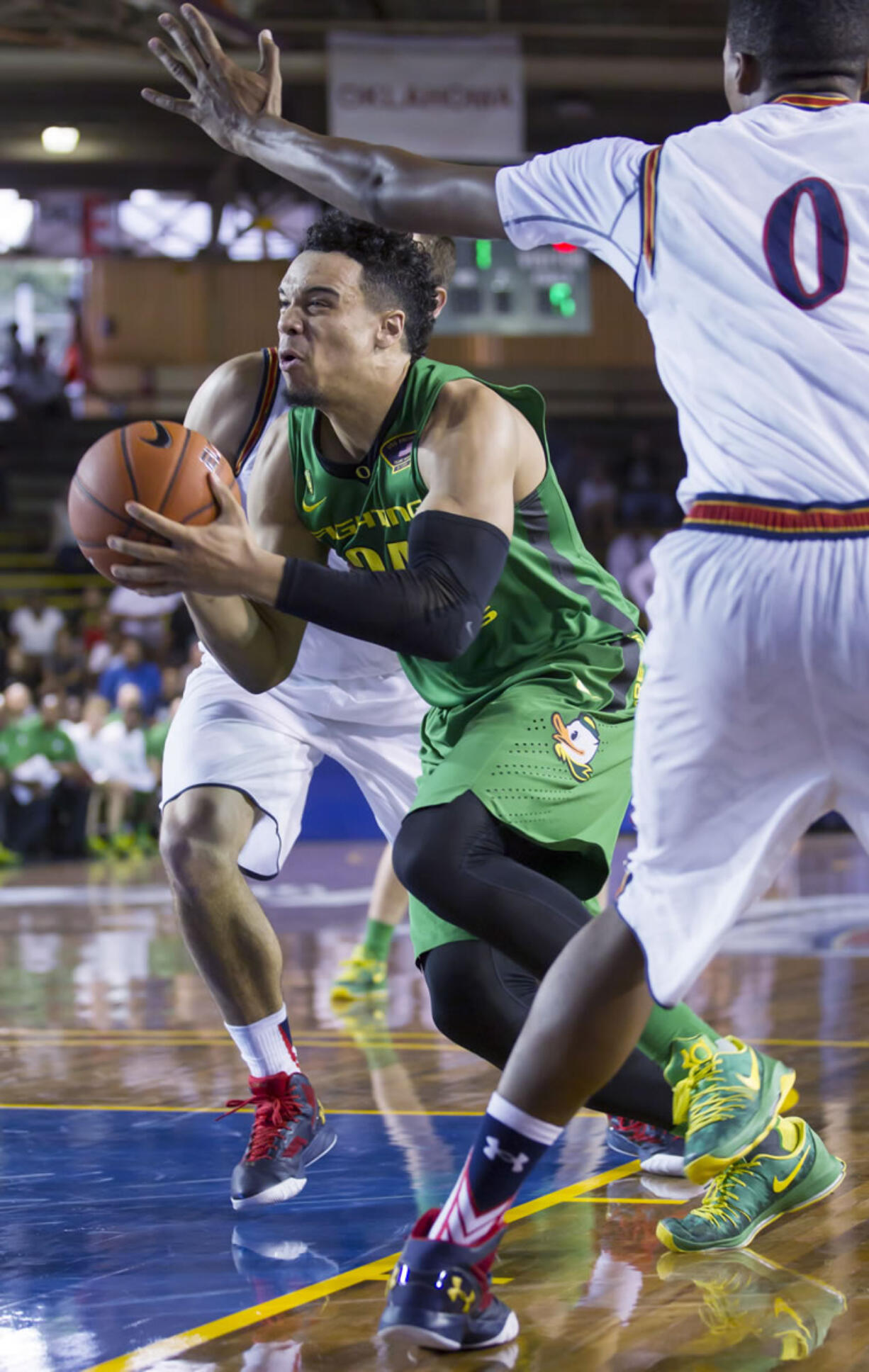 Oregon forward Dillon Brooks (24) drives to the basket while being defended by Navy center Will Kelly (0) in the first half of an NCAA college basketball game at the Pearl Harbor Invitational on Monday, Dec. 7, 2015, in Honolulu.