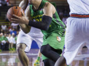 Oregon forward Dillon Brooks (24) drives to the basket while being defended by Navy center Will Kelly (0) in the first half of an NCAA college basketball game at the Pearl Harbor Invitational on Monday, Dec. 7, 2015, in Honolulu.