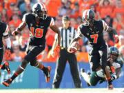 Oregon State's Brandin Cooks runs down field as Hawaii's Jerrol Garcia-Williams, bottom right, lunges at his feet during Saturday's game at Reser Stadium in Corvallis, Ore.