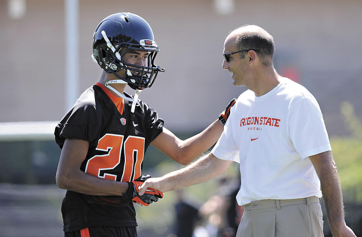 Oregon State University head football coach Mike Riley, greeting freshman cornerback Chris Hayes, enters his 13th season with the Beavers.