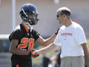 Oregon State University head football coach Mike Riley, greeting freshman cornerback Chris Hayes, enters his 13th season with the Beavers.