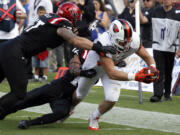 San Diego State defensive lineman Cody Galea, left, and defensive back David Lamar, stop Oregon State tight end Connor Hamlett, right, from scoring at the 1-yard line in the first half Saturday.