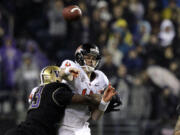 Oregon State quarterback Sean Mannion is hit by Washington's Andrew Hudson as he throws in the first half Saturday.