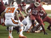 Washington State running back Marcus Mason (35) cuts inside in an effort to avoid safety Steven Christian (29) during the second half of an NCAA college football game Saturday, Oct. 12, 2013, at Martin Stadium in Pullman, Wash. Oregon State won 52-24.