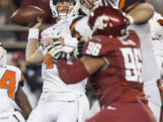 Oregon State quarterback Sean Mannion, left, attempts a pass during the first quarter against Washington State on Saturday, Oct. 12, 2013, at Martin Stadium in Pullman, Wash.