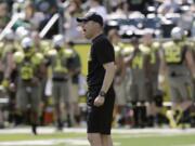 Oregon football coach Mark Helfrich shouts during their spring game in Eugene, Ore. Helfrich believes he is up to the task of keeping the Ducks flying high.