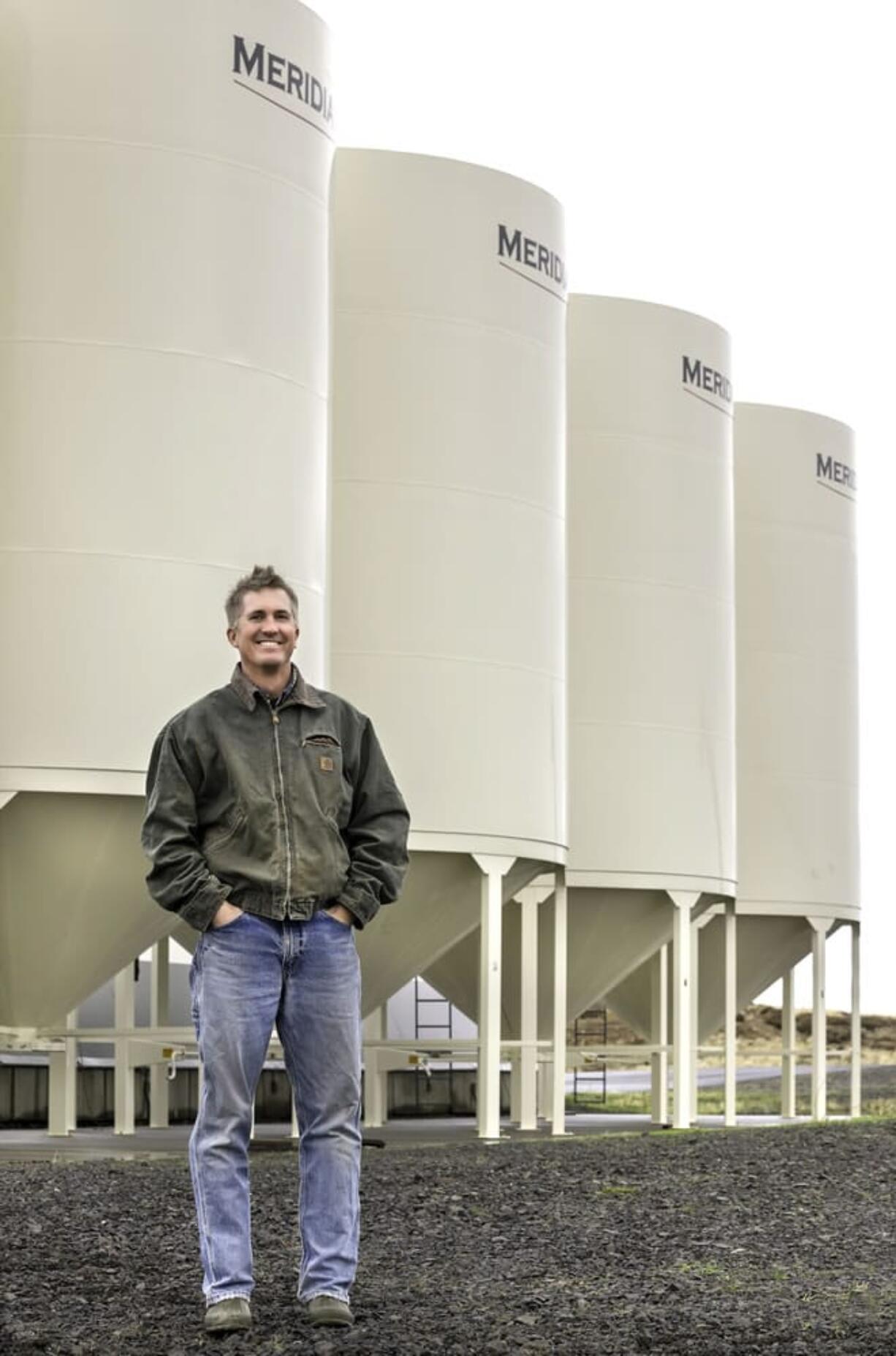 Certified organic farmer Eric Nelson stands in front of part of his crop in grain storage bins on his acreage north of Pendleton, Ore. Nelson knew it wouldn&#039;t be easy when he decided to go organic on his family&#039;s 900-acre wheat farm.