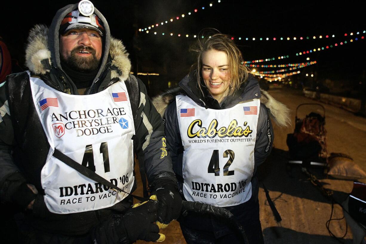 Tim Osmar of Ninilchik, Alaska, left, who drove his dog team in front of  Rachael Scdoris, right, as her visual interpreter during the Iditarod Trial Sled Dog Race, stands with Scdoris at the finish March 18, 2006, in Nome, Alaska. The 10th anniversary of Scdoris&#039; becoming the first legally blind musher to finish the Iditarod is just three months away.