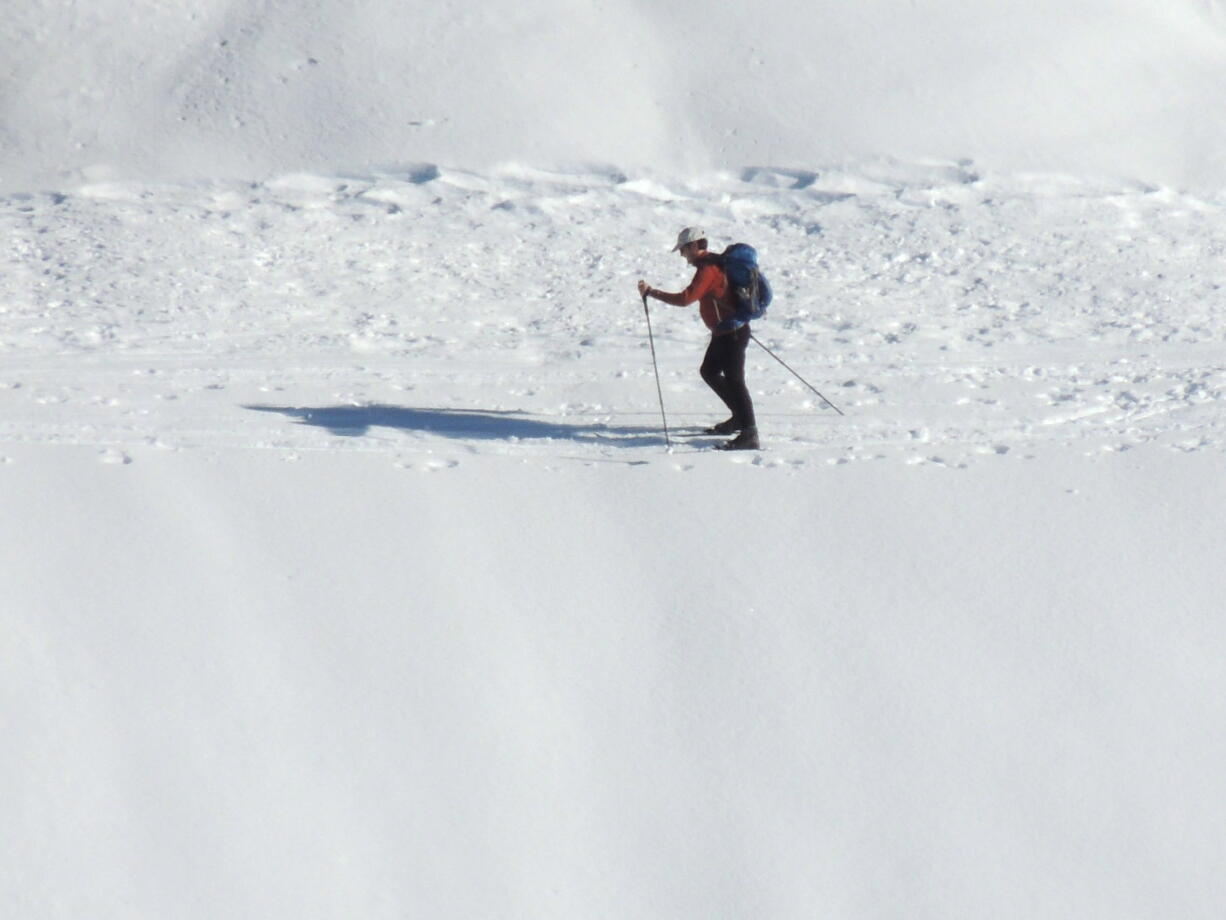 A man snowshoes in November on the Paradise Valley Road at Mount Rainier National Park. (Jeffrey P.