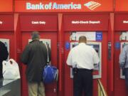 Customers use ATMs at a Bank of America branch office, in Boston.