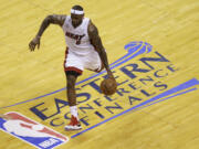 Miami Heat small forward LeBron James dribbles the ball during the first half of Game 7 against the Indiana Pacers on Monday.