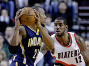 Portland Trail Blazers forward LaMarcus Aldridge, right, defends Indiana Pacers forward David West during the first quarter of an NBA basketball game in Portland, Ore., Wednesday, Jan. 23, 2013.