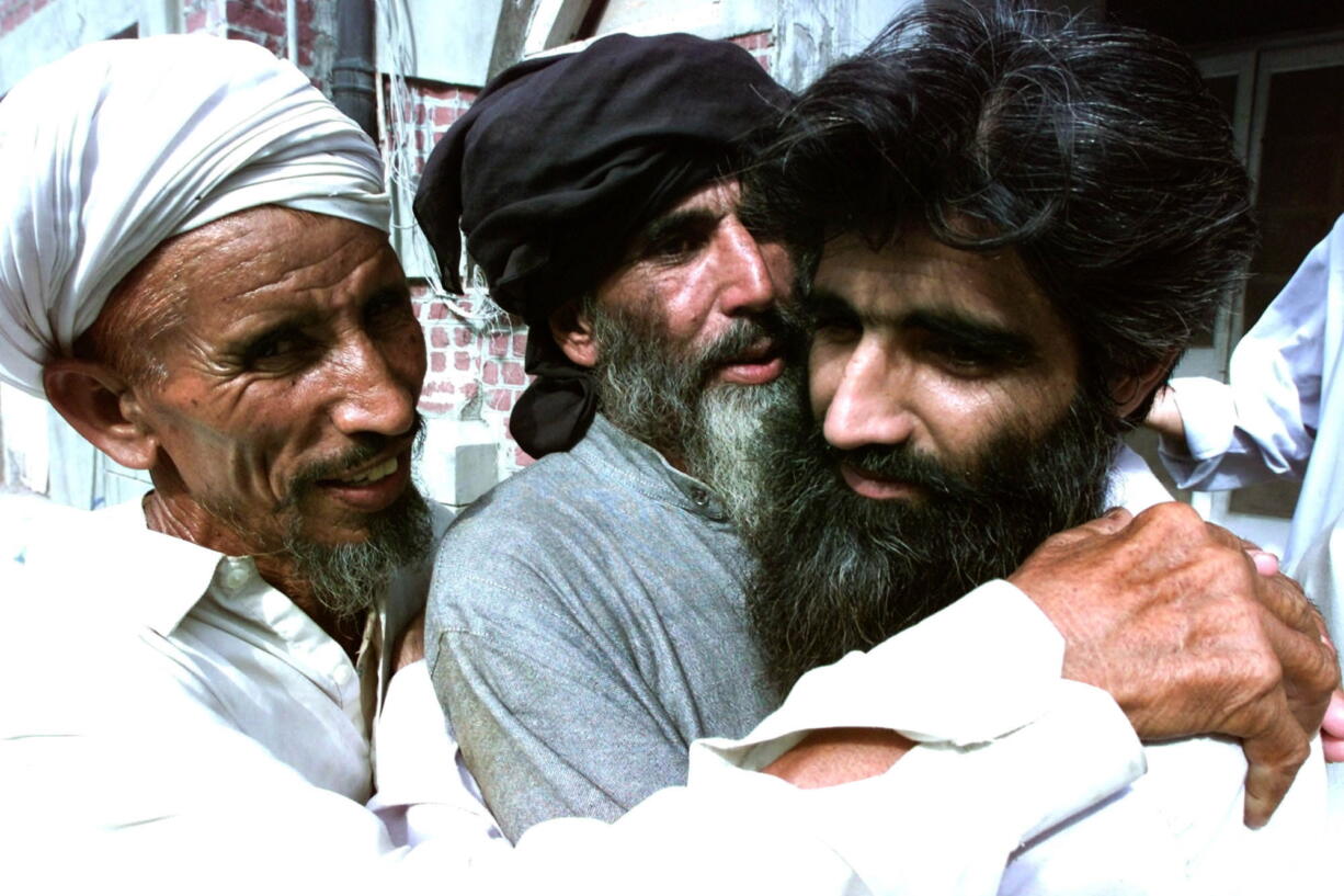 Taliban supporter Muhammad Jaffer, right, is received by his unidentified relatives after his release from the Kot Lakhpat Jail in Lahore, Pakistan.