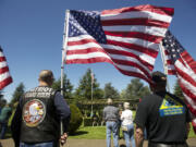 Patriot Guard Riders hold flags during a memorial service for veterans who did not receive a full military funeral in 2013 at Evergreen Memorial Gardens.