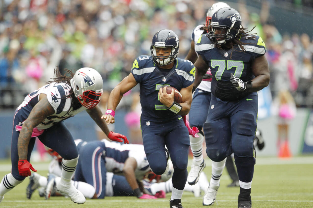 Seattle Seahawks quarterback Russell Wilson carries the ball in the first half of Seattle's 24-23 win over New England on Sunday in Seattle.