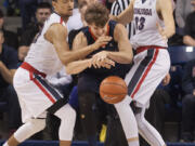 Gonzaga's Bryan Alberts, left, and Kyle Wiltjer (33) pressure Pepperdine's Jett Raines during the first half of an NCAA college basketball game Monday, Dec. 21, 2015, in Spokane,Wash.