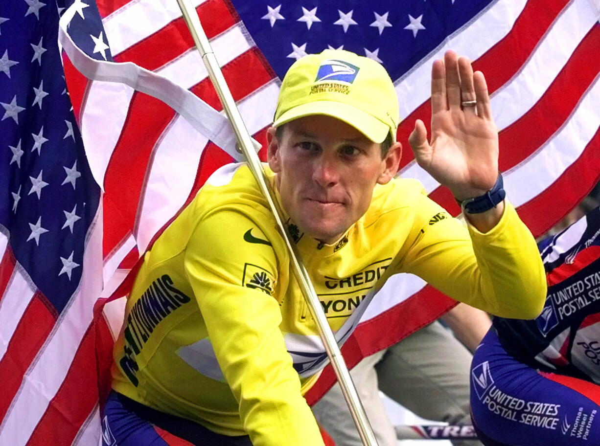 Winner Lance Armstrong rides down the Champs Elysees after the final stage of the Tour de France cycling race in July 2000 in Paris.