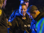 A police officer gives a thumbs up to another in Watertown, Mass., on Friday after the manhunt for the second of two suspects in the Boston Marathon bombing was captured.