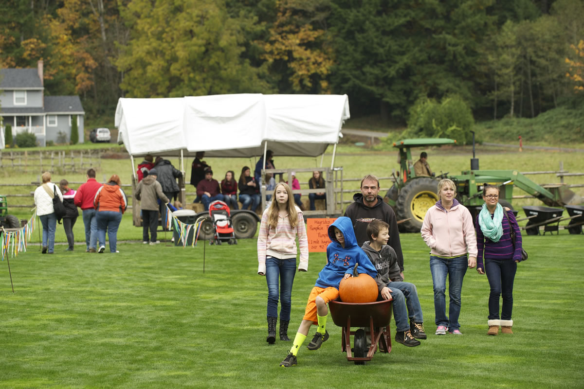 The Warnke family, from left, Janaya, 13, Ryan, 10, Darin, Shane, 10, Amy, and Darien Smith, 20, make their way to the car at the 18th annual Pumpkin Festival at Pomeroy Living History Farm on Oct.