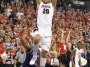 Gonzaga's Elias Harris (20) goes up for the dunk against Portland on Saturday.