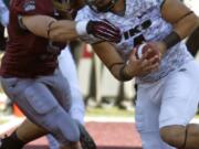 Montana defensive end Zack Wagenmann, left, grabs Portland State quarterback Kieran McDonagh (4) in the end zone during the first quarter Saturday.