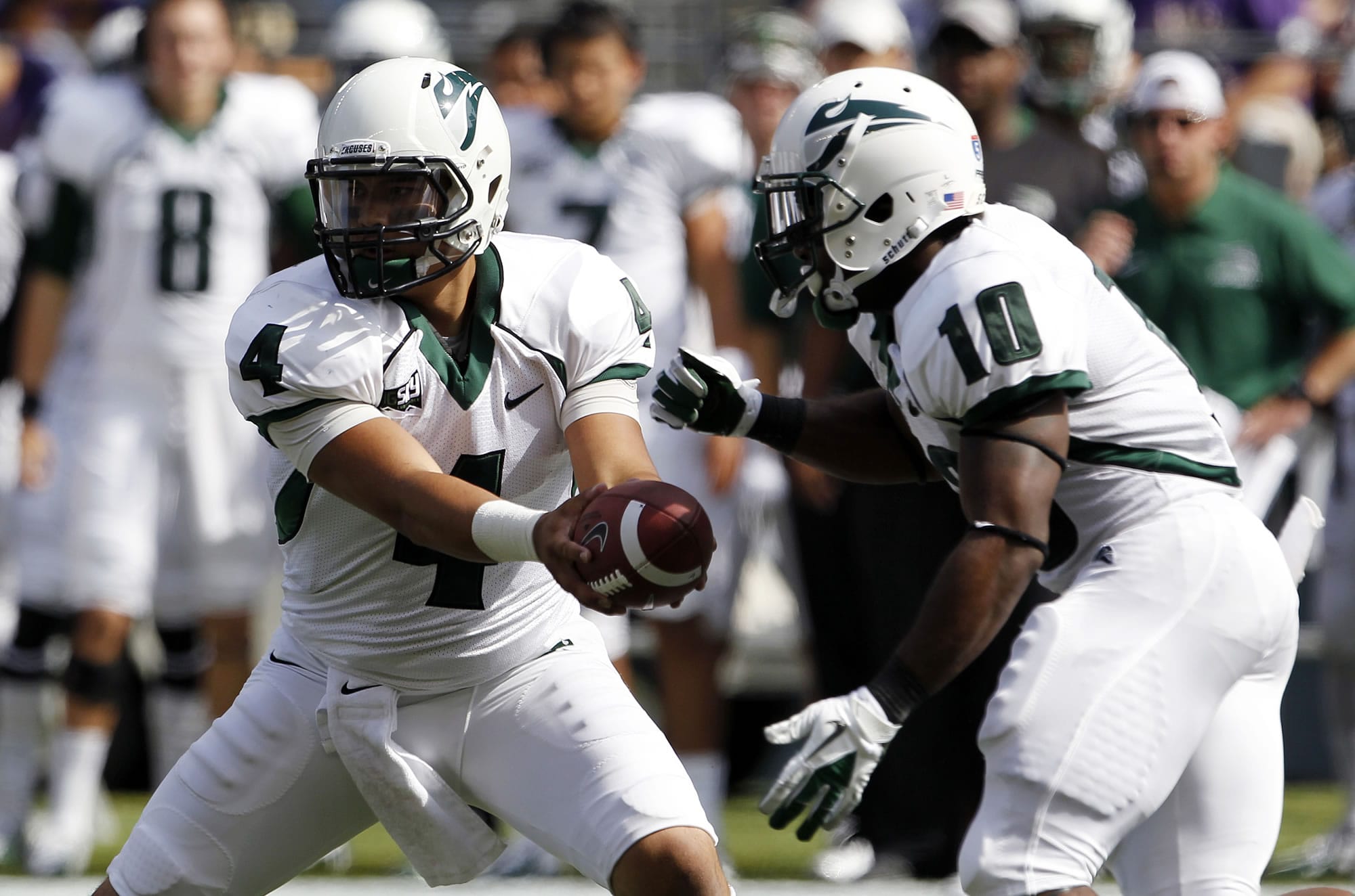 Portland State quarterback Kieran McDonagh (4) hands off to DJ Adams in the first half Saturday against Washington.