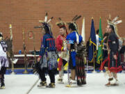 Native American dancers greet each other at the Traditional pow-wow at Covington Middle School.