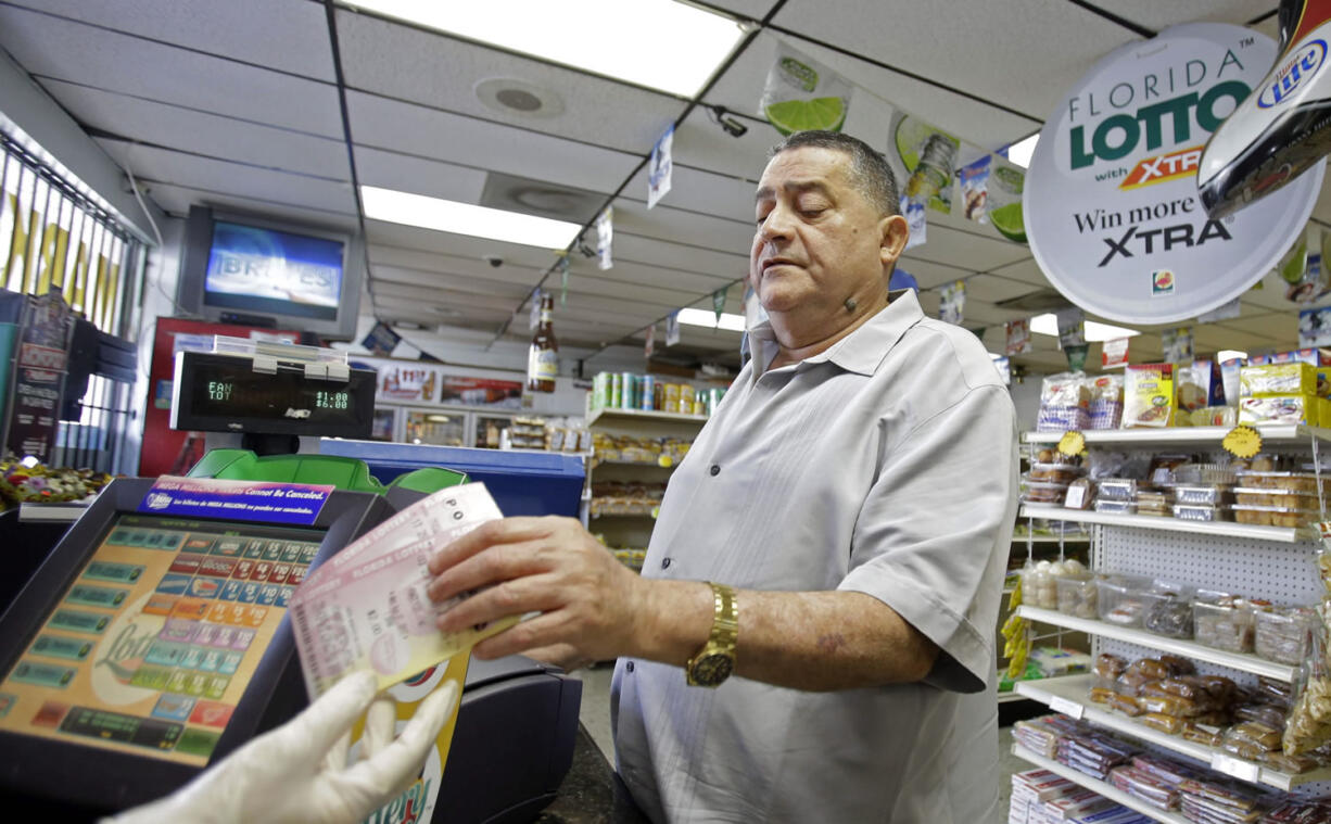 Remberto Gonzalez purchases Powerball lottery tickets at a local store in Hialeah, Fla., on Tuesday.