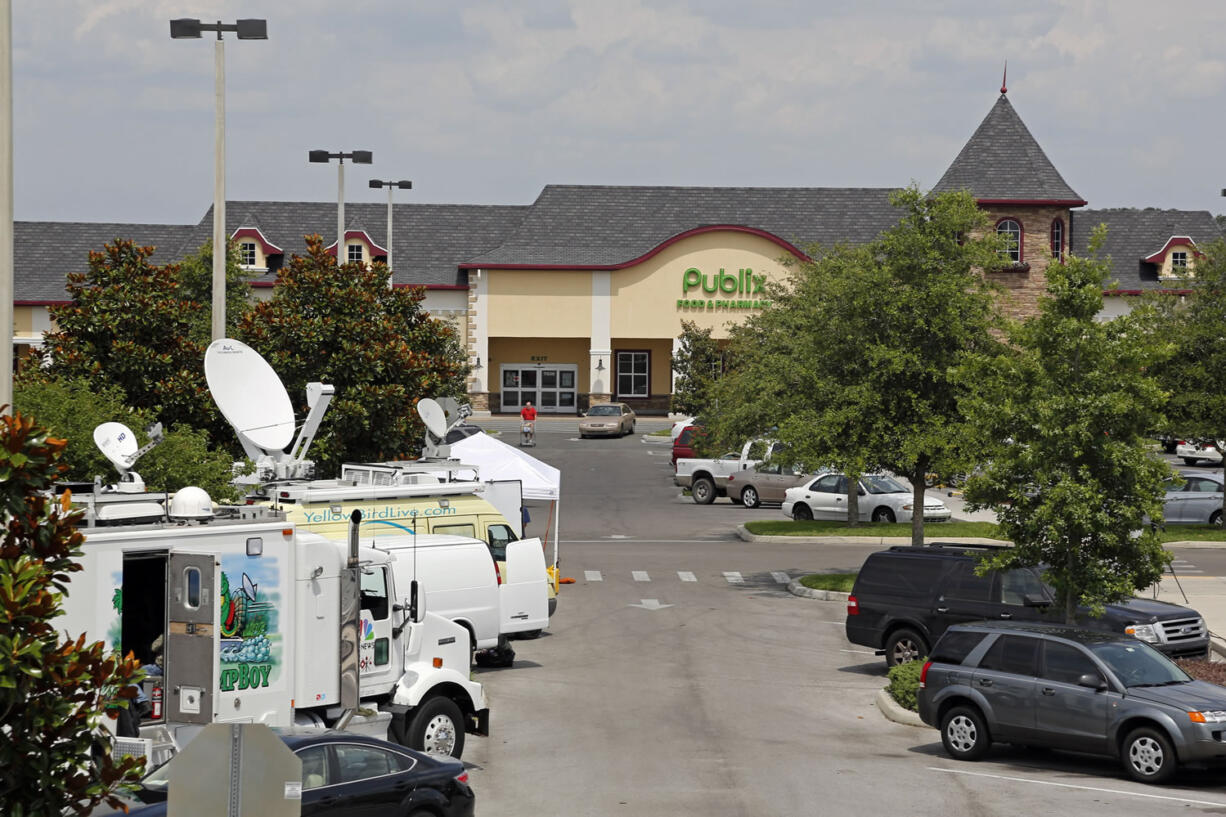 Satellite trucks line the parking lot of the Publix supermarket in Zephyrhills, Fla., where a Powerball ticket worth an estimated $590.5 million was sold.