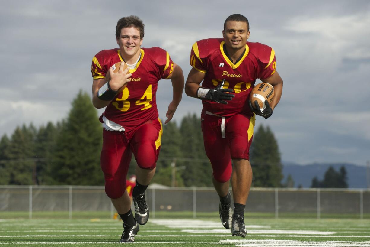 Prairie running backs Dallas Goodpaster, left, and Denzel Hamiel pose for a portrait during practice at Prairie High School.