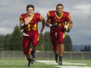 Prairie running backs Dallas Goodpaster, left, and Denzel Hamiel pose for a portrait during practice at Prairie High School.