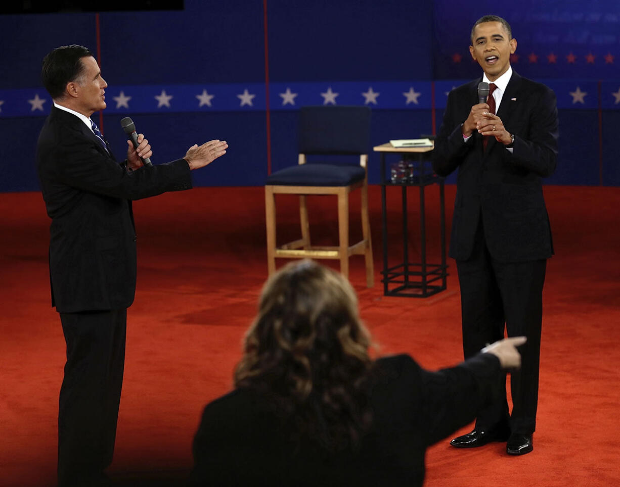 Republican presidential nominee Mitt Romney and and President Barack Obama answer a question during the second presidential debate at Hofstra University on Tuesday in Hempstead, N.Y.