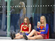 Denis Poroy/Invision
Joy Donaldson, left, dressed as Wonder Woman, and Everleigh Reed, dressed as Supergirl, take a break July 28 at the 2013 Comic-Con International Convention in San Diego.