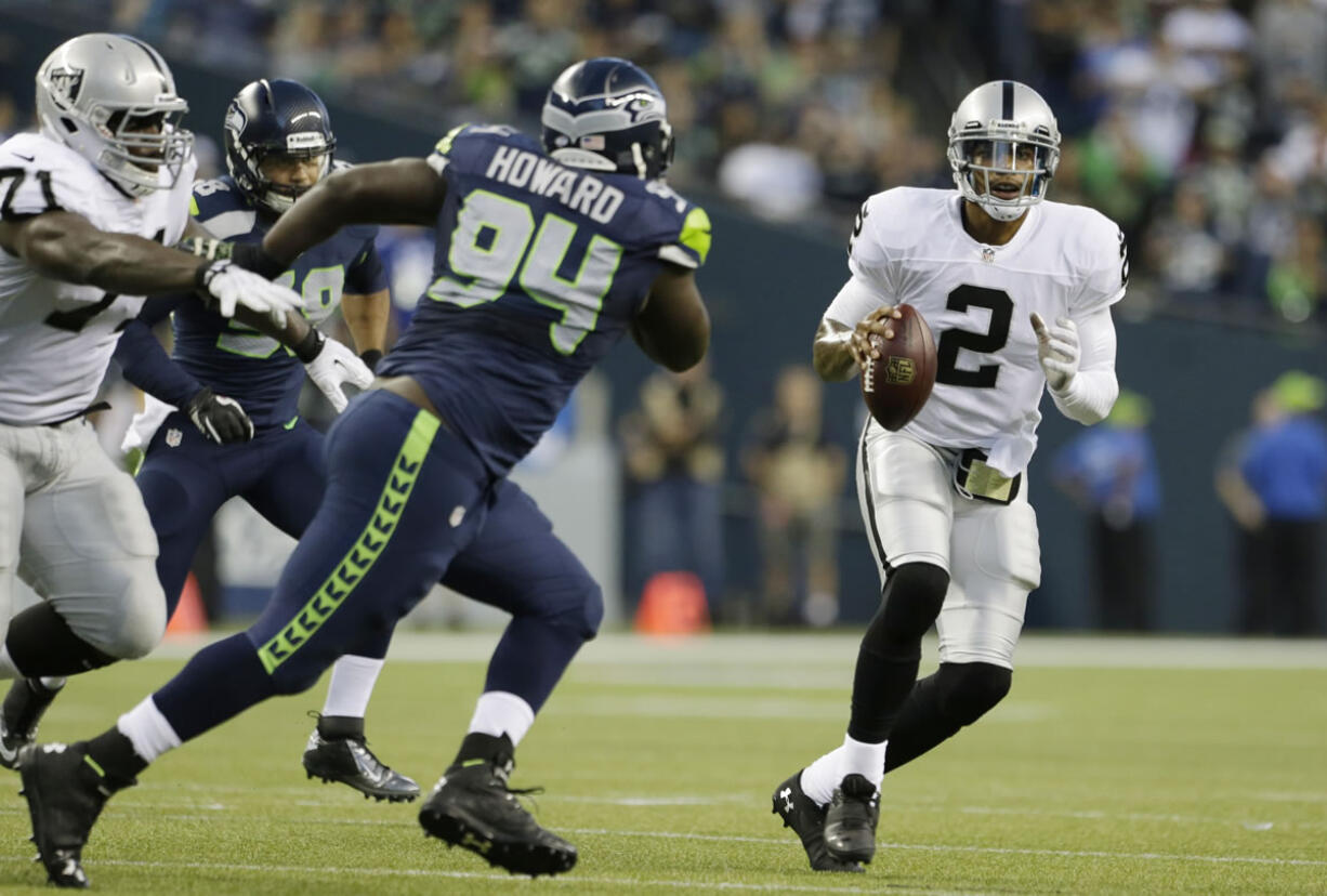 Seattle's Jaye Howard (94) pressures Oakland quarterback Terrelle Pryor in a preseason game last week.