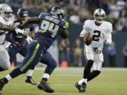 Seattle's Jaye Howard (94) pressures Oakland quarterback Terrelle Pryor in a preseason game last week.