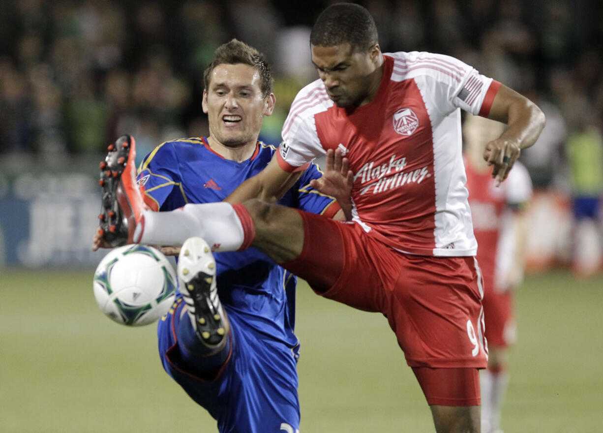 Portland forward Ryan Johnson, right, battles for possession with Colorado defender Shane O'Neill.