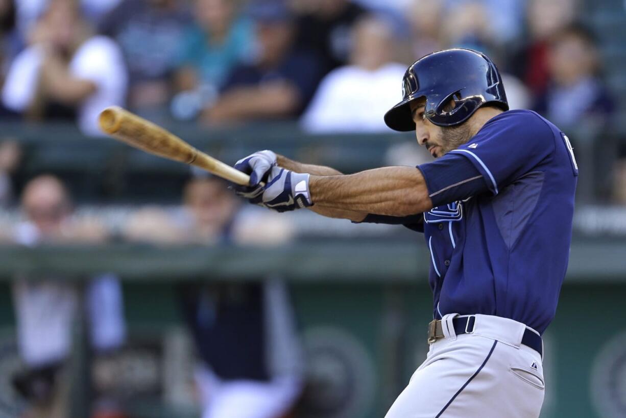 Tampa Bay Rays' Sean Rodriguez hits a two-run single against the Seattle Mariners in the eighth inning Sunday.