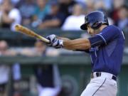 Tampa Bay Rays' Sean Rodriguez hits a two-run single against the Seattle Mariners in the eighth inning Sunday.