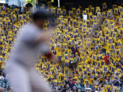 Fans in the &quot;King's Court&quot; special cheering section for Seattle Mariners starting pitcher Felix Hernandez hold up &quot;K cards&quot; calling for a strikeout as Boston Red Sox batter Jonny Gomes waits for a pitch in the first inning.