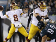 Washington Redskins' Kirk Cousins looks to pass in the first half of an NFL football game against the Philadelphia Eagles, Saturday, Dec. 26, 2015, in Philadelphia.