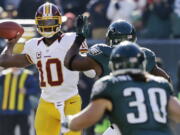 mel evans/The Associated Press
Washington Redskins quarterback Robert Griffin III presents a double threat to Seattle's defense.