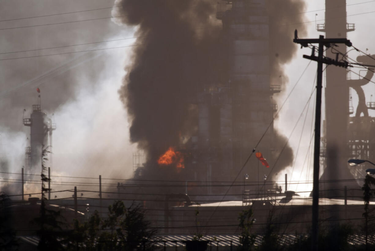 Smoke and flame billow from a crude oil unit at the Chevron refinery in Richmond, Calif., on Monday.