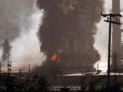 Smoke and flame billow from a crude oil unit at the Chevron refinery in Richmond, Calif., on Monday.