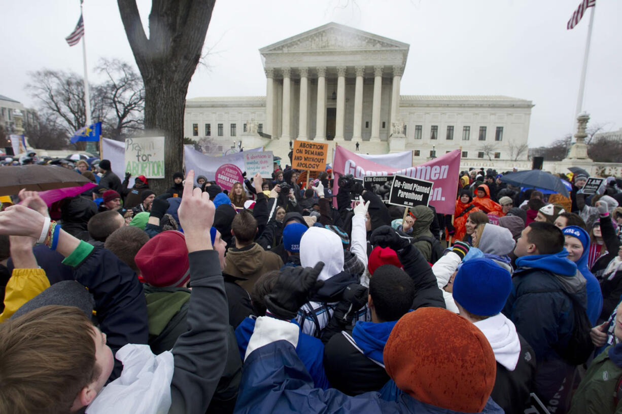 Anti-abortion and abortion rights supporters face off in front of the Supreme Court in Washington, on Jan.