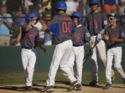 Ridgefield's Joe David Lindbo (00) celebrates with teammates after hitting a home run in Monday's game at the Washington State Little League tournament at Luke Jensen Sports Park in Vancouver.