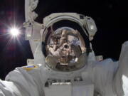 NASA
International space station astronaut Aki Hoshide takes a self-portrait Sept. 18,while in space. The practice of freezing and sharing our tiniest slices of life in &quot;selfies&quot; has become so popular that the granddaddy of dictionaries, the Oxford, is monitoring the term as a possible addition.