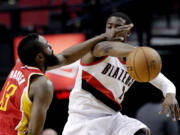 Houston Rockets guard James Harden, left, plays tight defense on Portland Trail Blazers guard Wesley Matthews during the first quarter Friday.