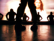 As The Rocky Horror Picture Show plays on a screen behind them, members of the audience take to the stage to dance to the &quot;time warp&quot; song.