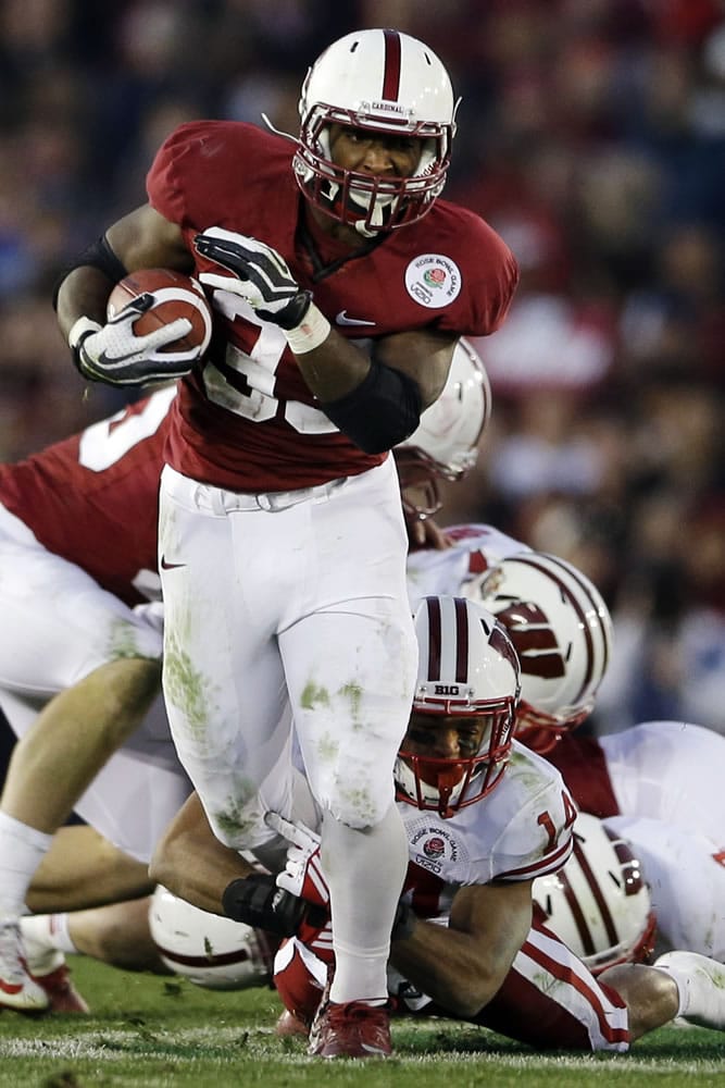 Stanford running back Stepfan Taylor breaks through Wisconsin defensive back Nate Hammon (14) during the second half Tuesday.