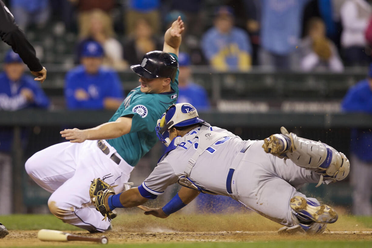 Kansas City Royals catcher Salvador Perez tags out Seattle Mariners base runner Kyle Seager at home plate when Seager tried to score on a sacrifice fly during the 10th inning Monday.